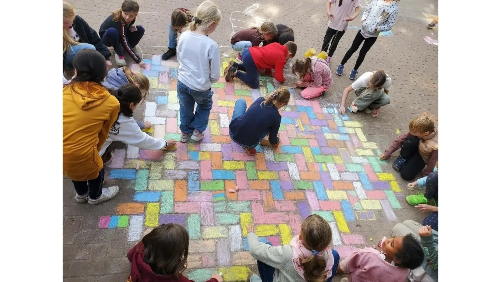 Die Kinder gestalten den Schulhof mit bunter Straßenkreide.  (Foto: privat)