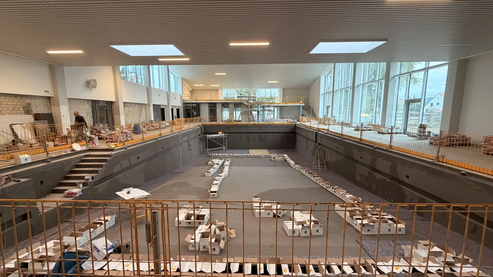 Das Schwimmerbecken im sanierten Hallenbad „Rinorca“ bekommt jetzt den finalen Belag. Über die Außengestaltung gibt es derzeit Diskussionen. (Foto: ste)